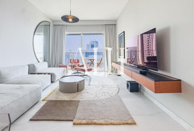 Living space with floor-to-ceiling glass and water views