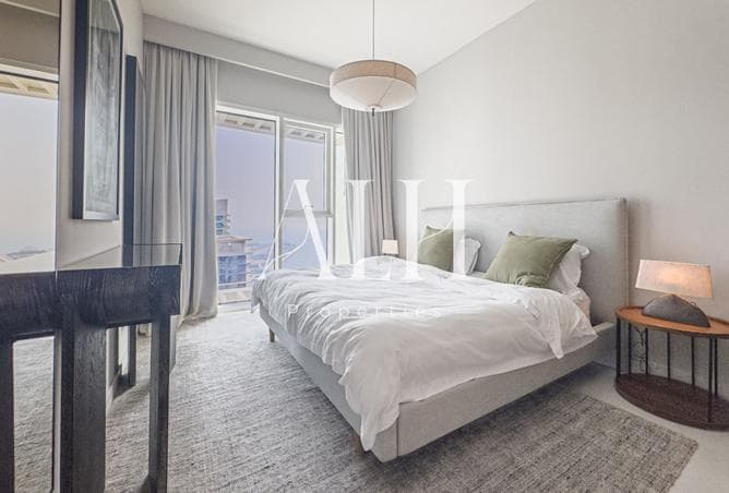 Bedroom with balcony access and water view