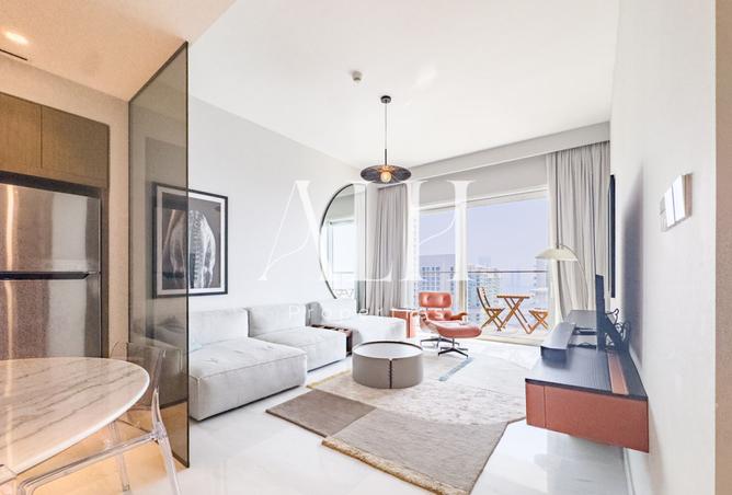Grand Bleu Tower 2 one bedroom — bright living space opening to a sea-view balcony